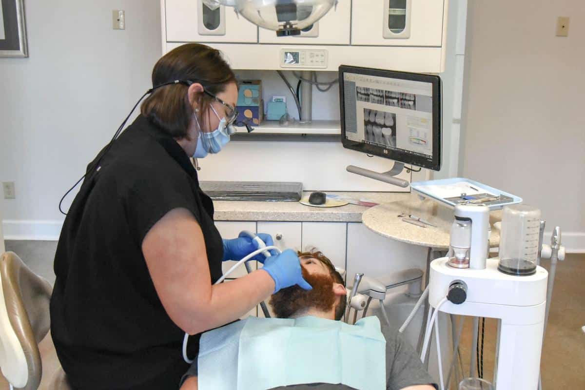 dental patient in chair getting teeth cleaned