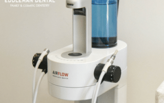 Guided Biofilm Therapy machine in office with Eddleman logo at top left