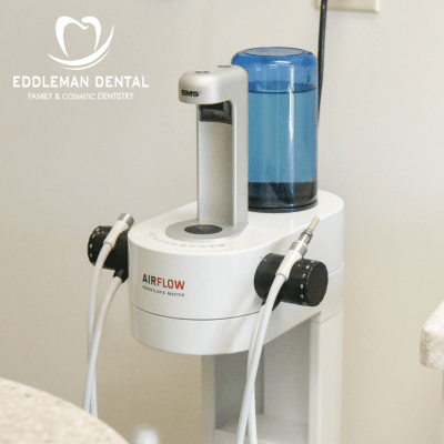 Guided Biofilm Therapy machine in office with Eddleman logo at top left