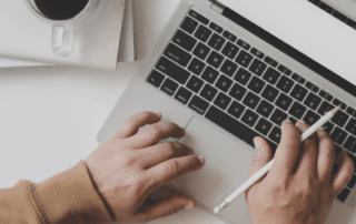 Photo of someone typing on a laptop