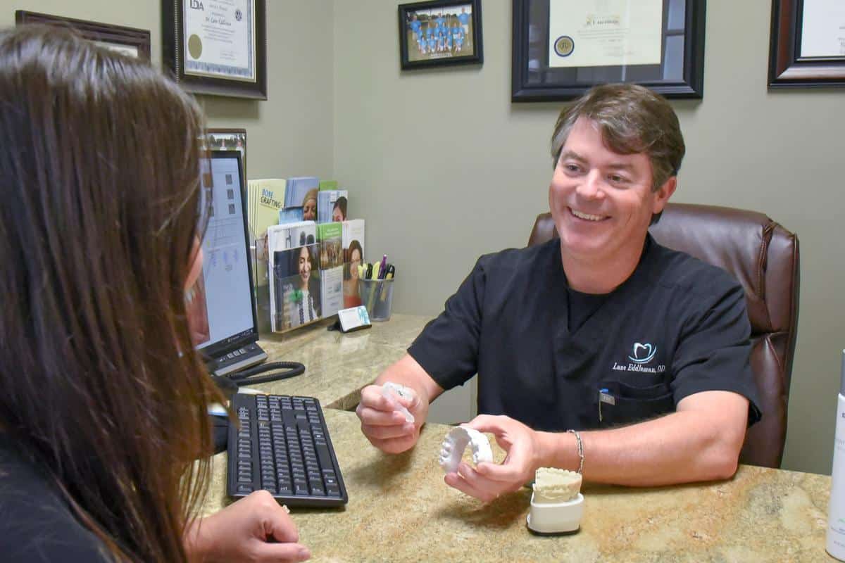 dr eddleman in office smiling with patient