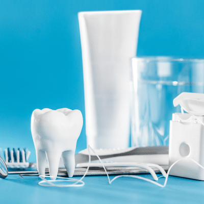 Items such as tooth brush, floss, and more that represent the importance of oral health