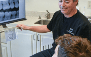 Dr. Eddleman discussing cosmetic dentistry with patient for boosting self-confidence