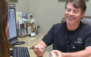 Dr. Eddleman meeting with a patient in his office at Eddleman Dental Family & Cosmetic Dentistry