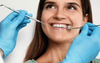 Woman getting her teeth worked on at the dentist, representing common cosmetic dental issues