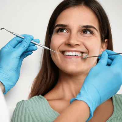 Woman getting her teeth worked on at the dentist, representing common cosmetic dental issues